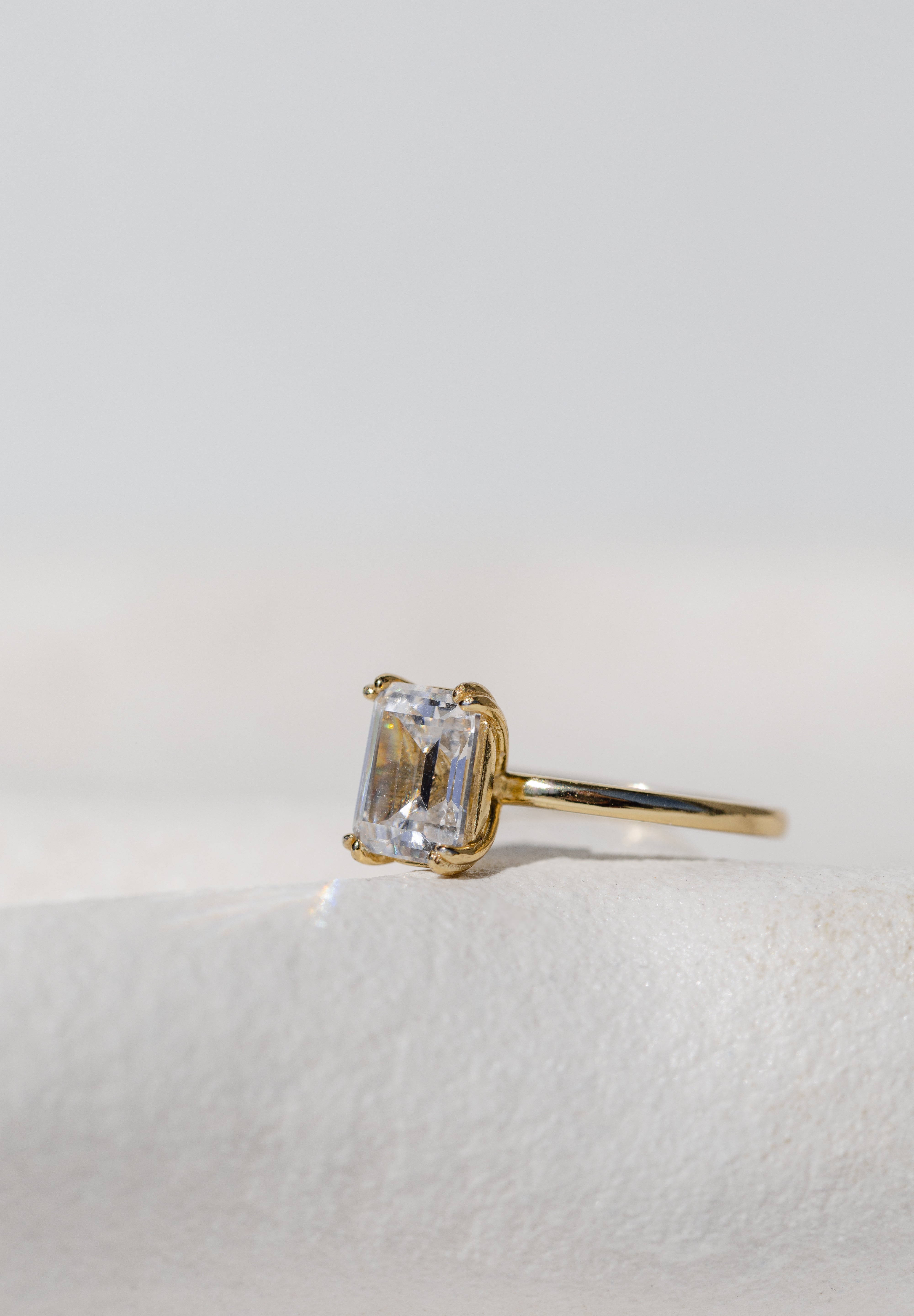 DOUBLE CLAW EMERALD CUT SOLITAIRE RING