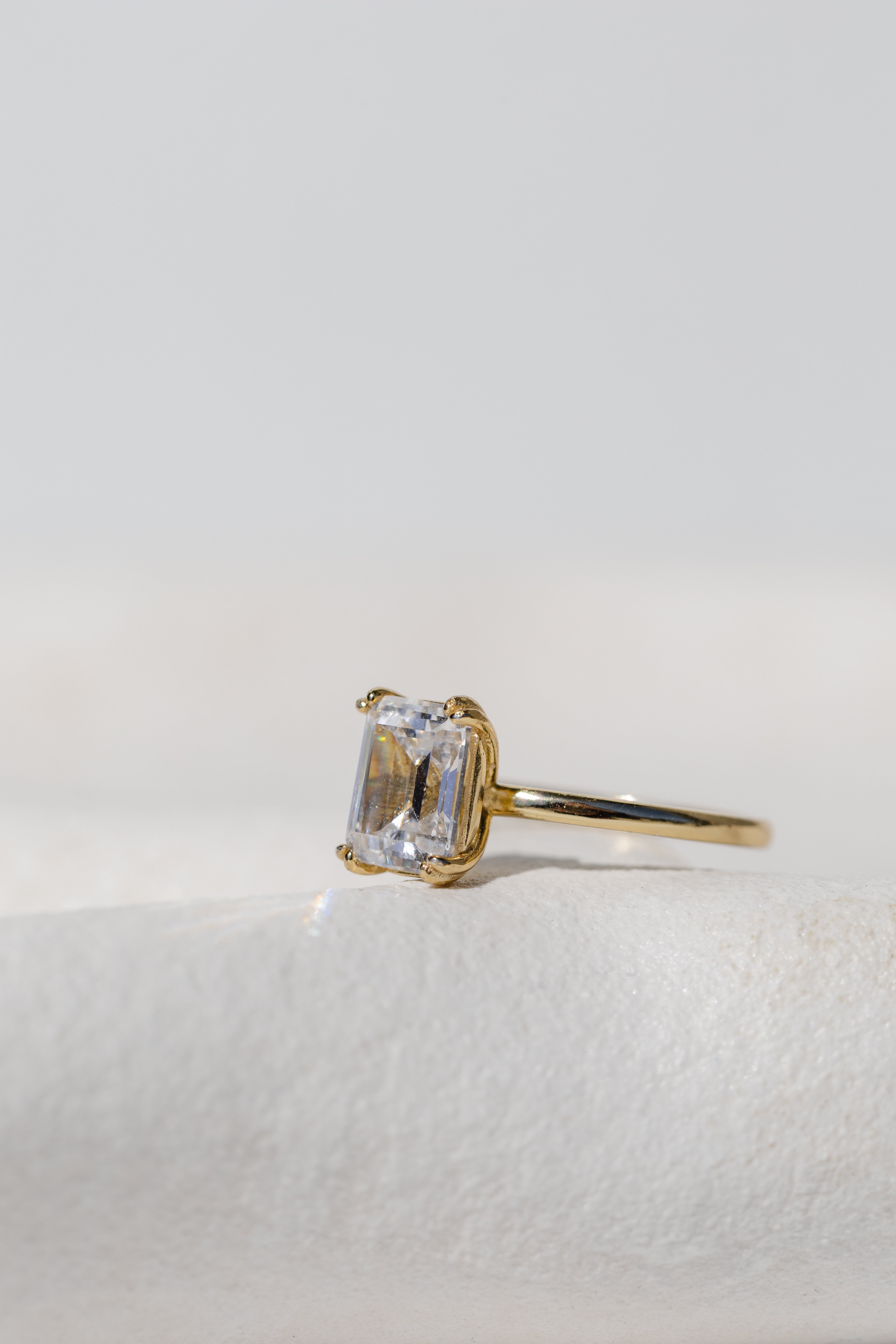 DOUBLE CLAW EMERALD CUT SOLITAIRE RING