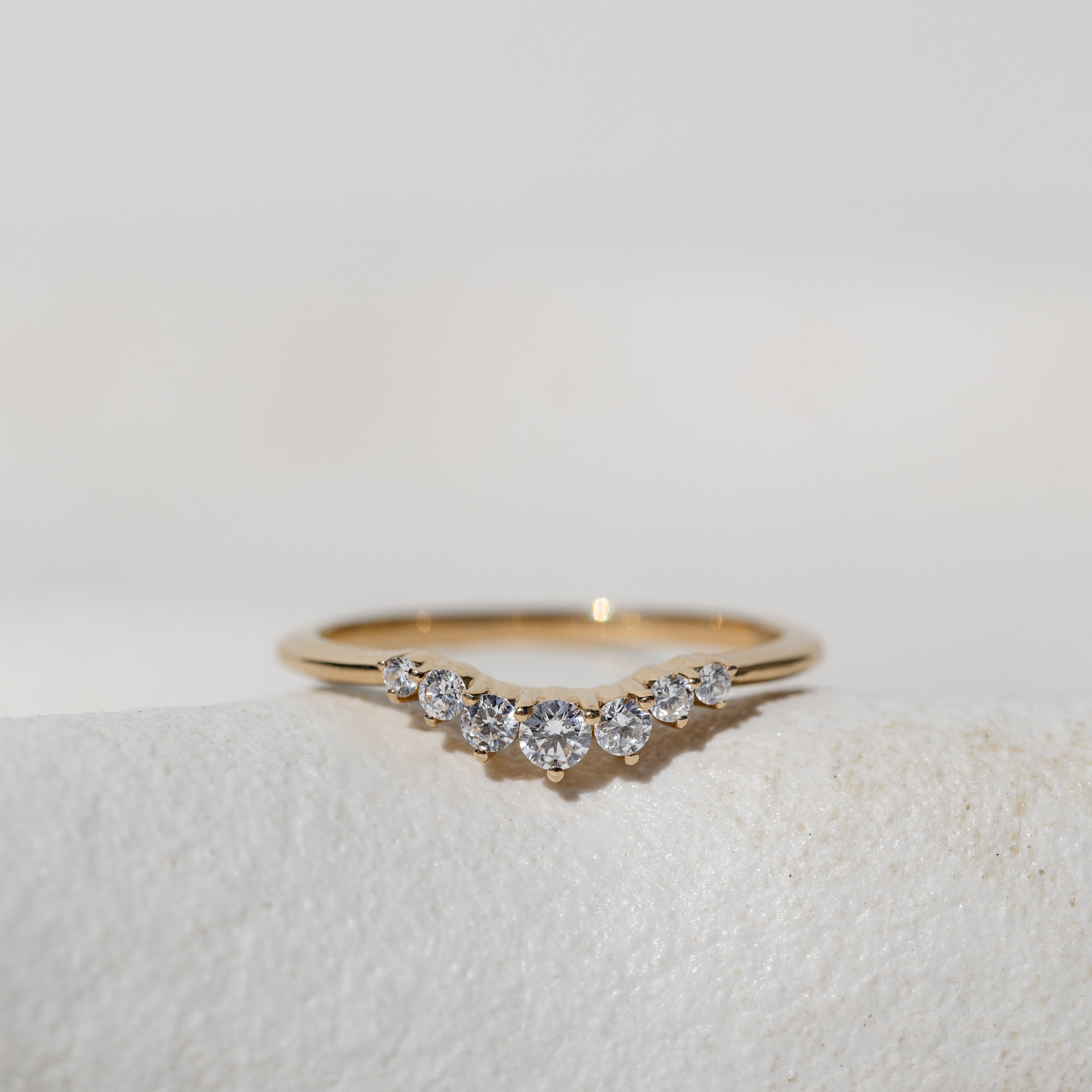 GRADUATED CROWN RING - A CURVED DIAMOND RING WITH DIAMONDS GRADUATING FROM BIGGER TO SMALLER