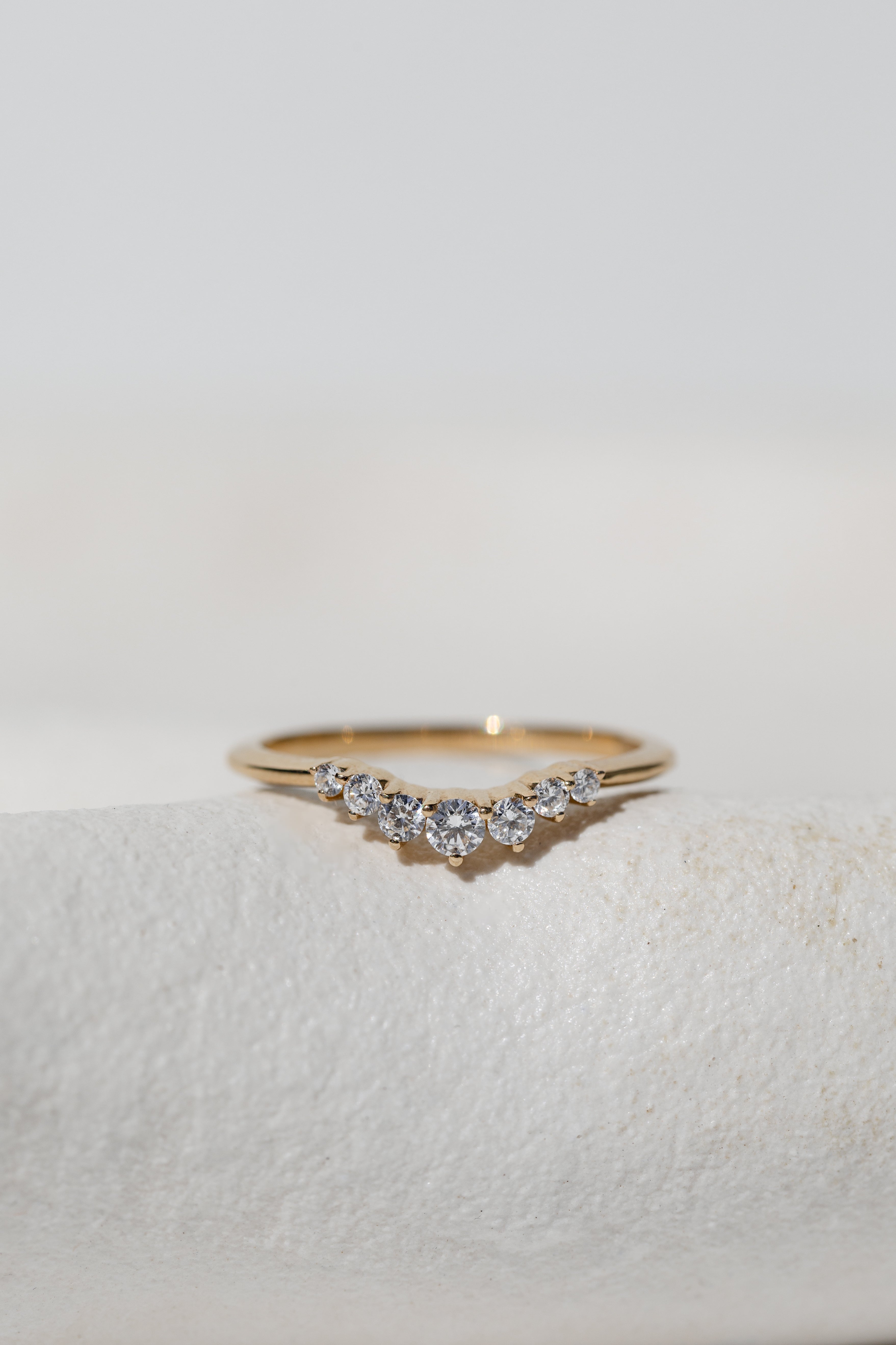GRADUATED CROWN RING - A CURVED DIAMOND RING WITH DIAMONDS GRADUATING FROM BIGGER TO SMALLER