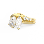 Gold curved wedding ring with diamonds around toi et moi engagement ring