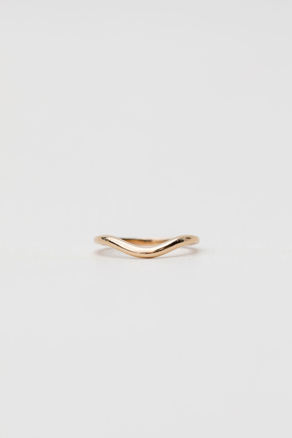 Gold curved wedding ring