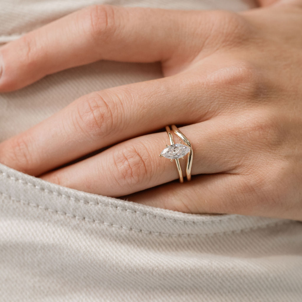 Marquise Cut Solitaire engagement ring with curved gold wedding ring