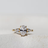 OVAL WITH PEAR SIDE STONES THREE STONE TRILOGY ENGAGEMENT RING