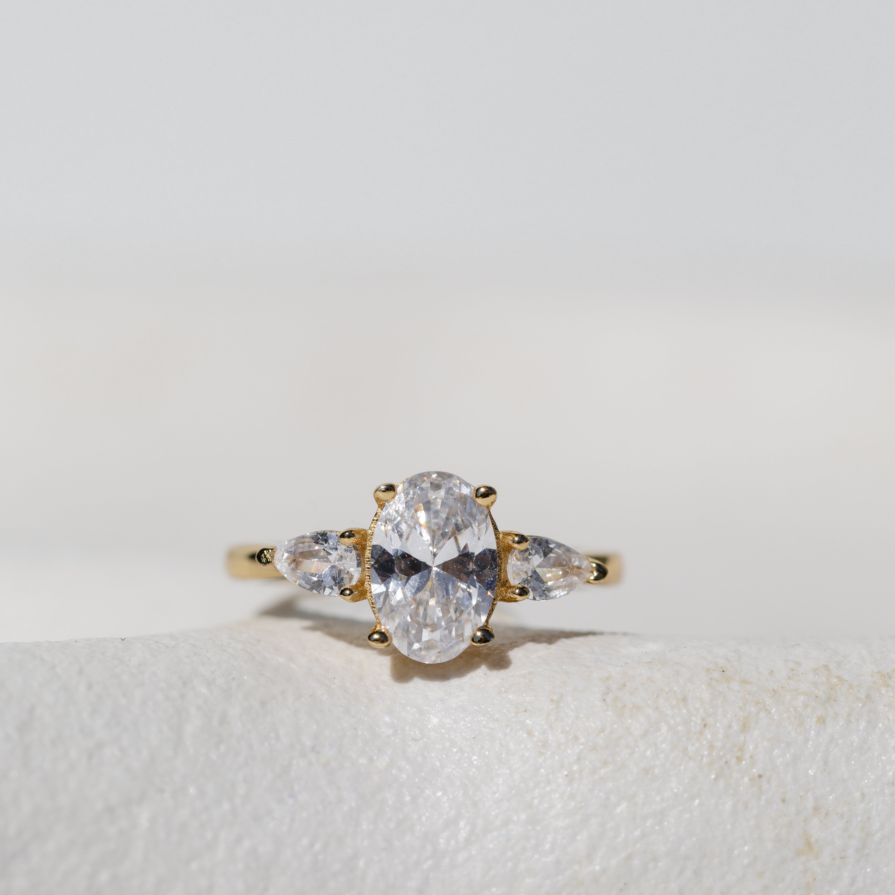 OVAL WITH PEAR SIDE STONES THREE STONE TRILOGY ENGAGEMENT RING