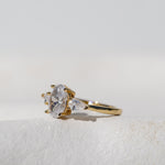 OVAL WITH PEAR SIDE STONES THREE STONE TRILOGY RING