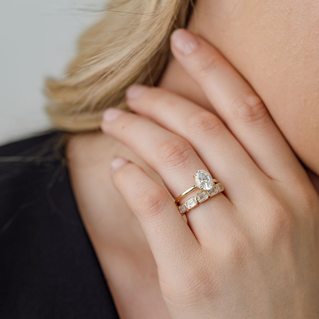 Oval Cut Diamond Solitaire engagement ring with bezel set emerald cut diamond wedding ring