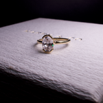 oval diamond engagement ring half bezel set in gold