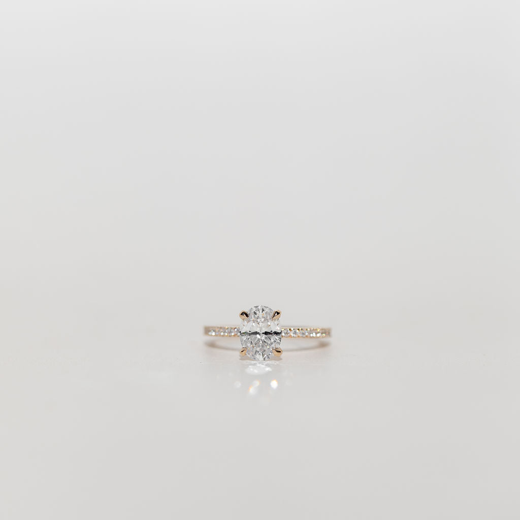 Oval diamond engagement ring with pave diamonds in the band