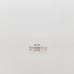 Oval diamond engagement ring with pave diamonds in the band