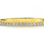 Pave set diamonds and a millgrain edge wedding ring  yellow gold 