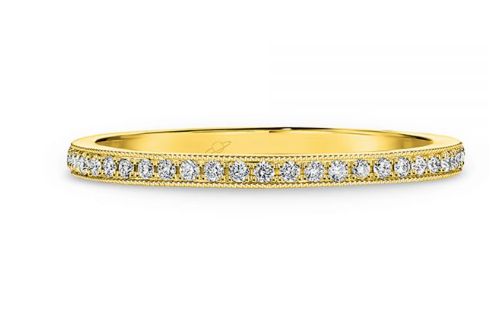 Pave set diamonds and a millgrain edge wedding ring  yellow gold 