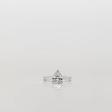 Pear cut diamond engagement ring with diamond band
