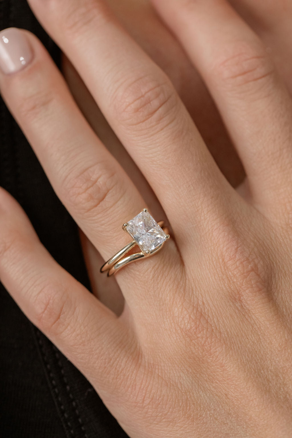 radiant cut diamond solitaire engagement ring with curved gold wedding ring