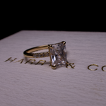 Radiant diamond side stone engagement ring