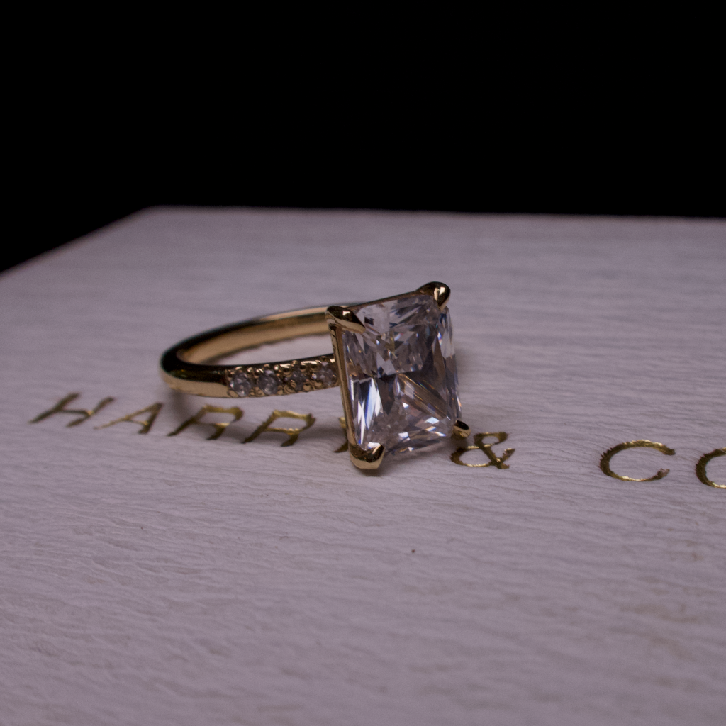 Radiant diamond side stone engagement ring