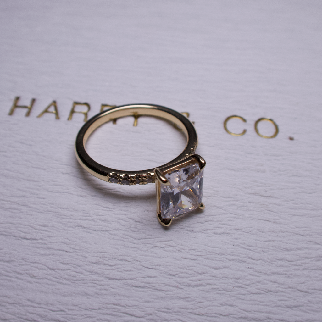 Radiant with side stone engagement ring y