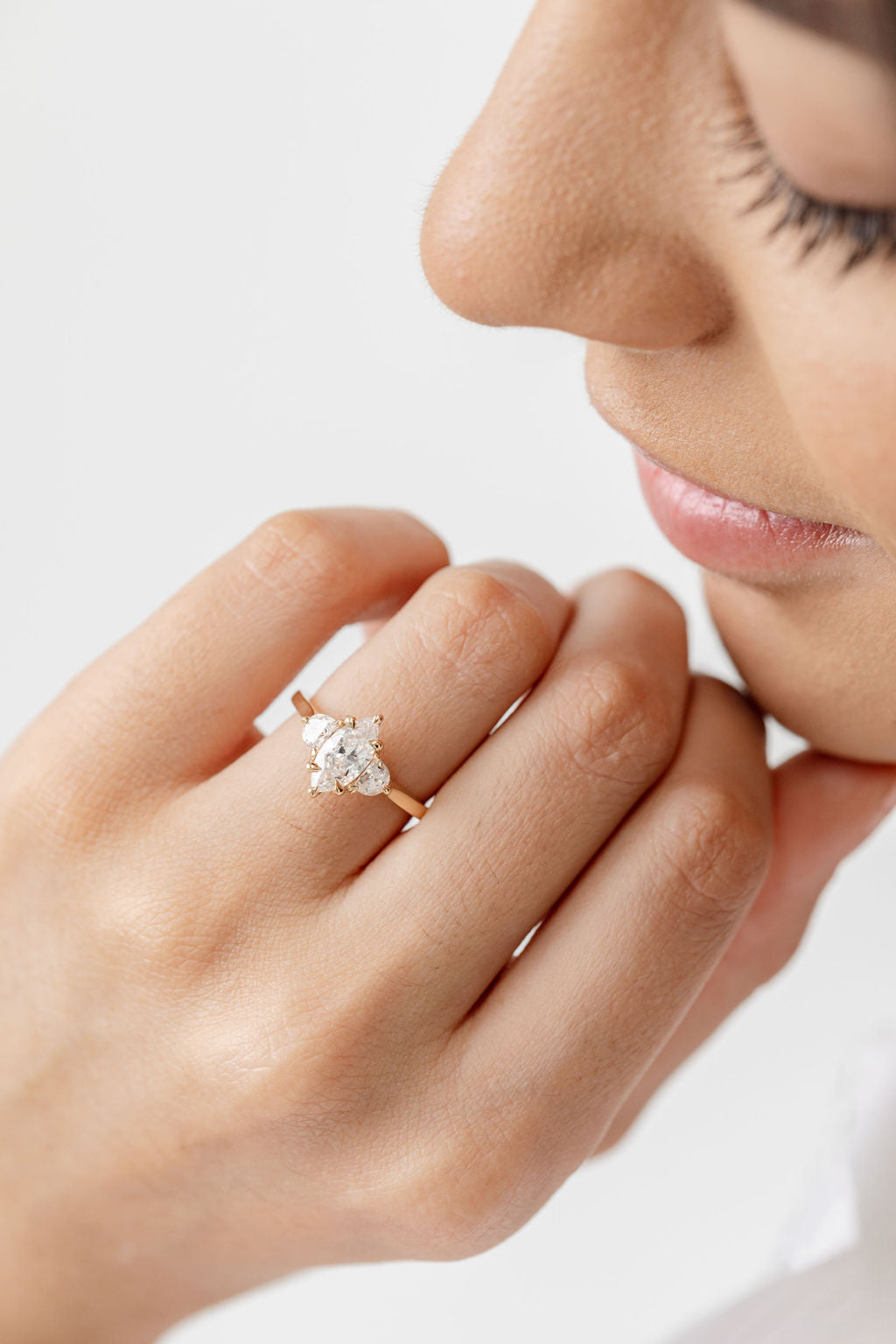 Three stone diamond engagement ring with marquise centre stone and half moon cut diamond side stones