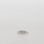 Trilogy Three stone ring with a round cut centre diamond and brilliant cut side stones