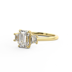 Trilogy engagement ring with emerald cut centre and trapezoid side stones Harry & Co