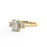 Trilogy engagement ring with emerald cut centre and trapezoid side stones Harry & Co