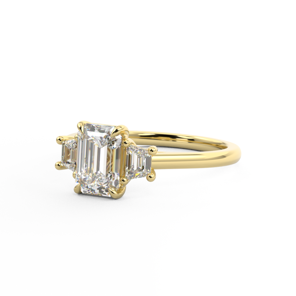 Trilogy engagement ring with emerald cut centre and trapezoid side stones Harry & Co