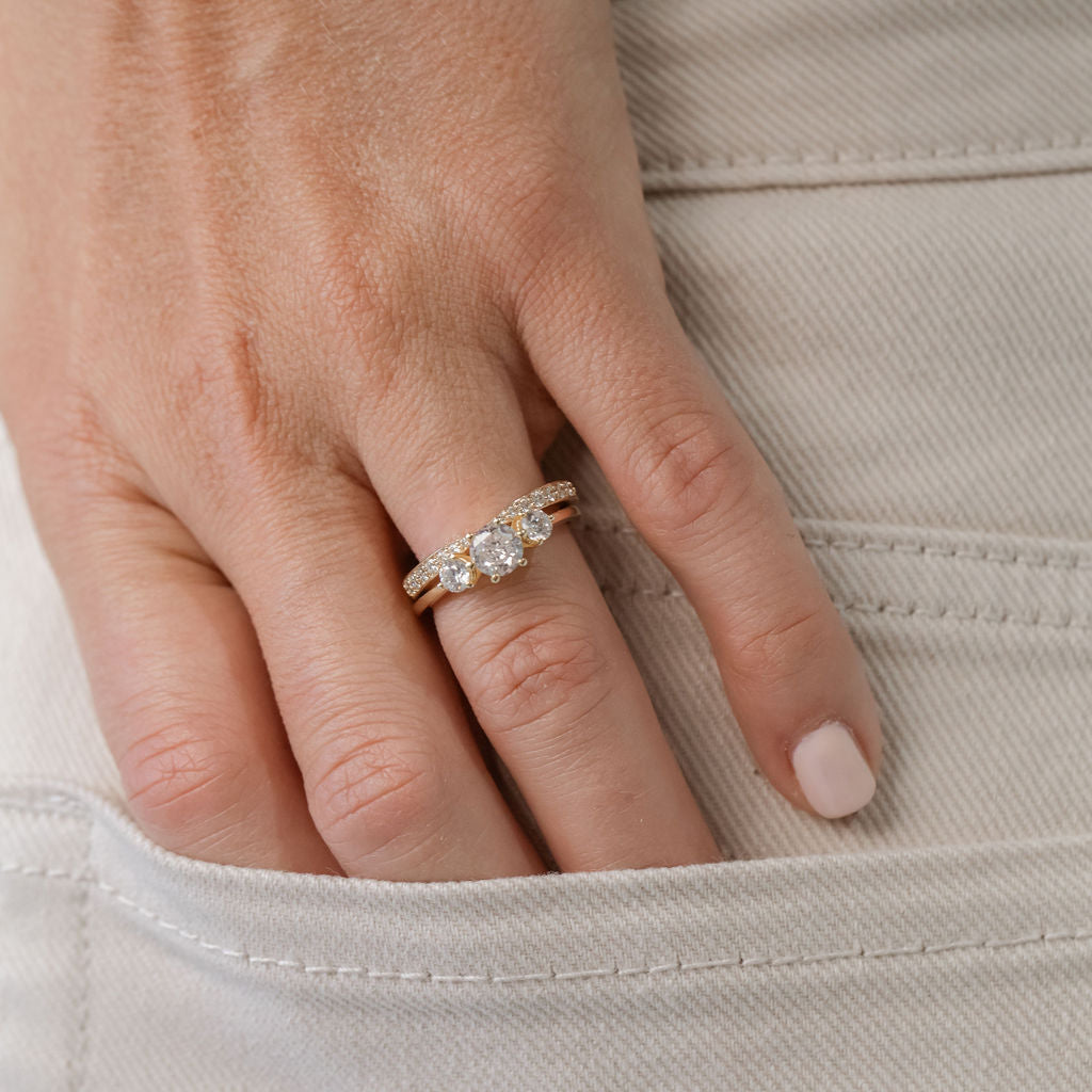 Trilogy three stone engagement ring with diamond wedding ring