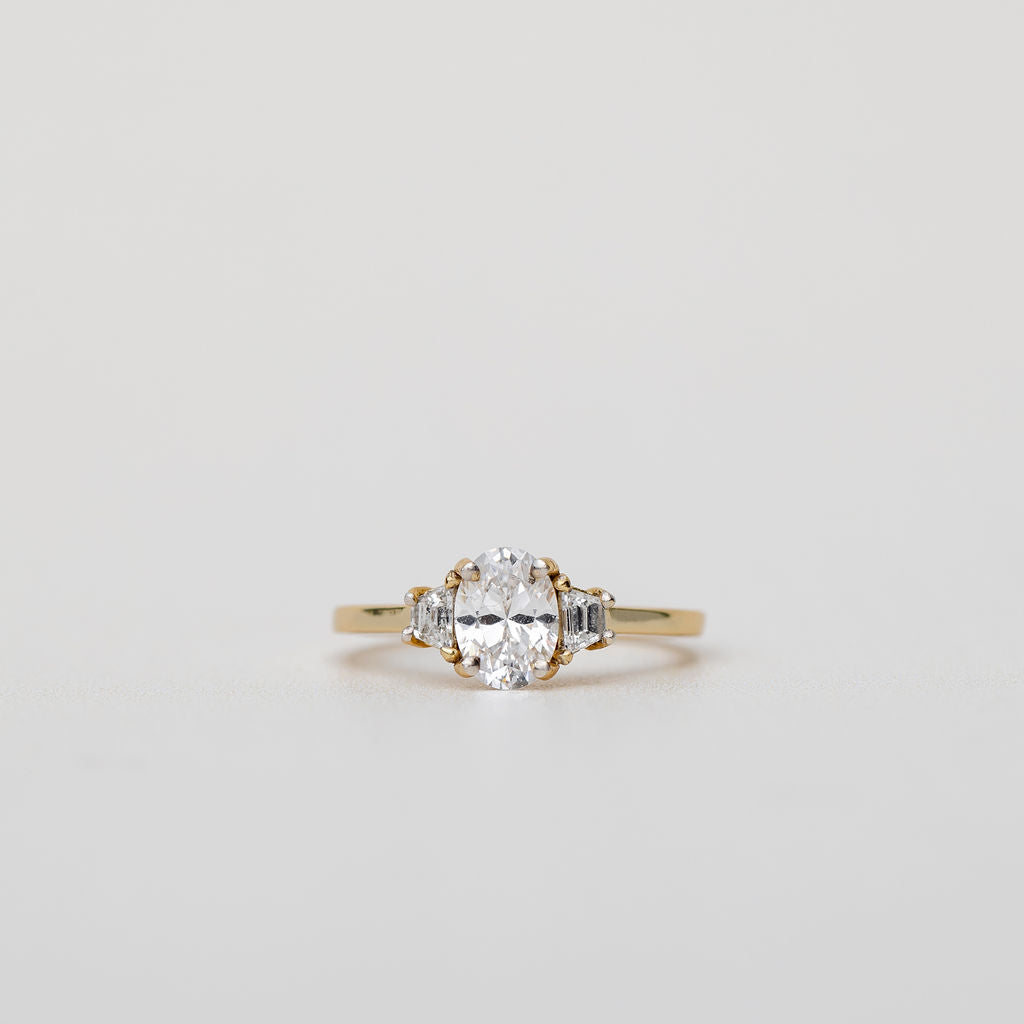 Trilogy three stone engagement ring with oval centre diamond