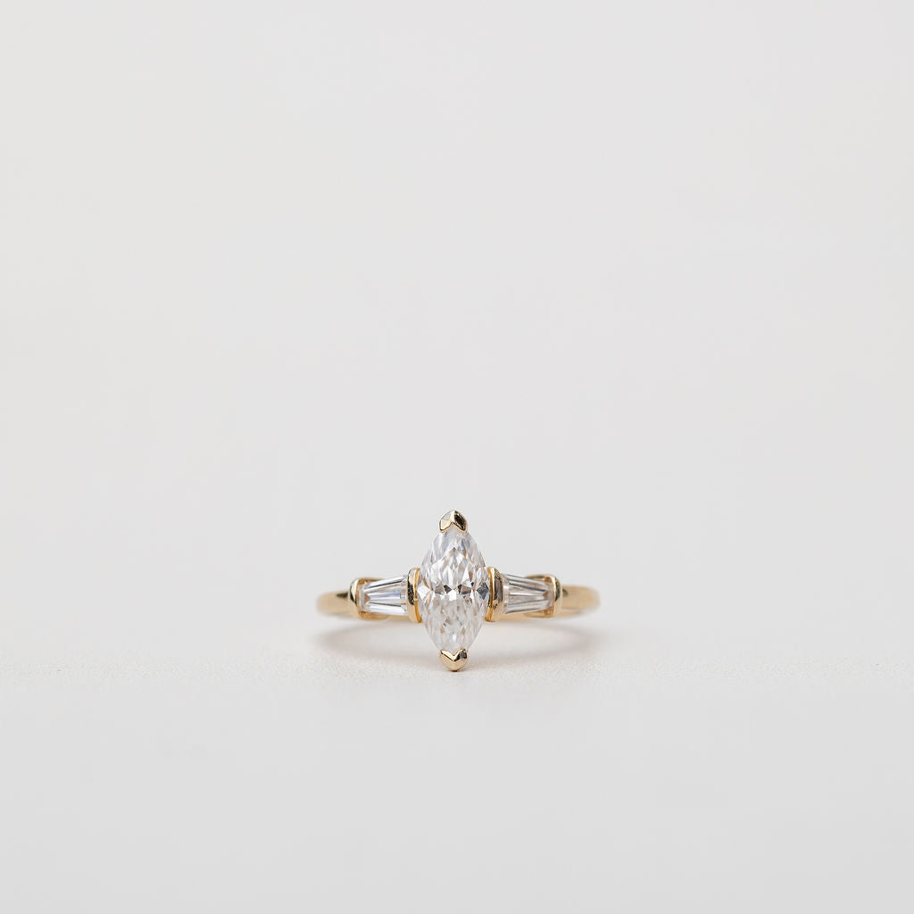 Trilogy three stone ring with marquise diamond centre
