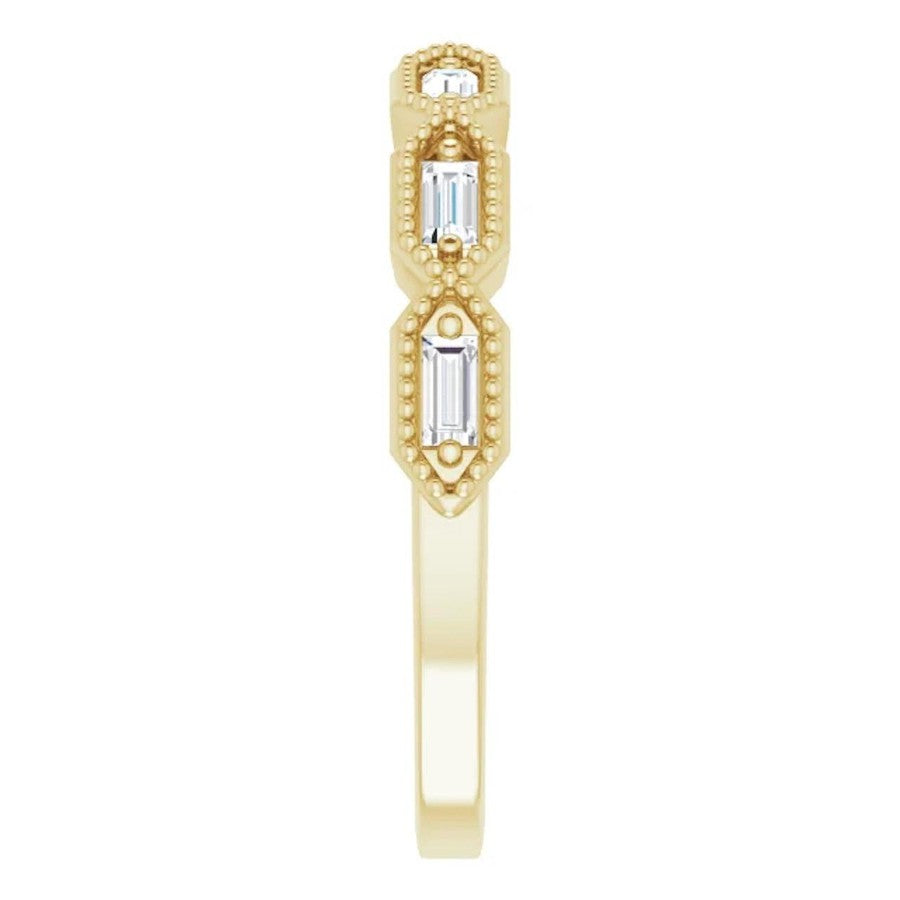 yellow gold diamond eternity ring with baguette cut diamonds and millgrain edge