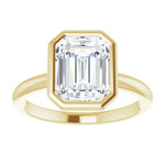 bezel set emerald cut engagement ring in yellow gold