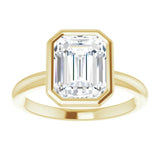 bezel set emerald cut engagement ring in yellow gold