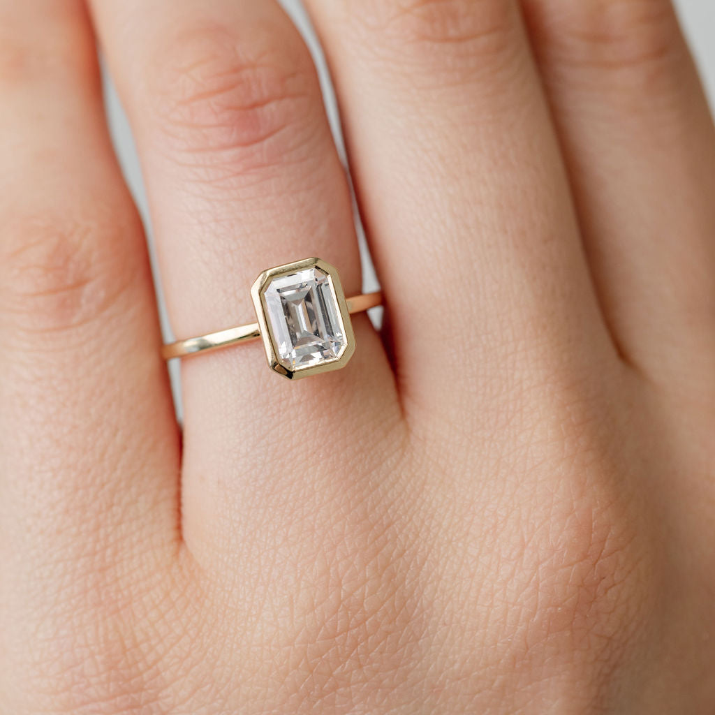 bezel set emerald cut diamond engagement ring