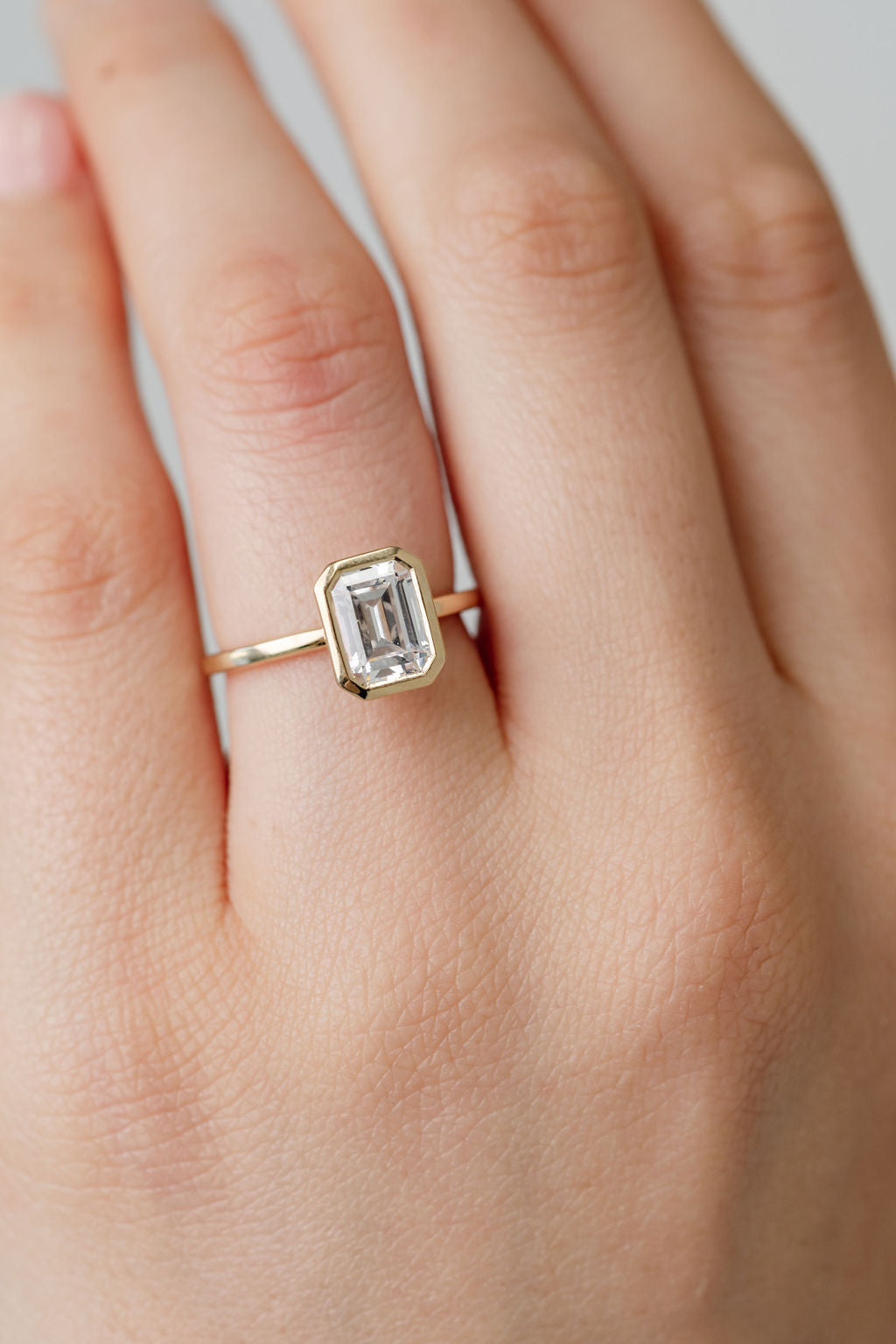 bezel set emerald cut diamond engagement ring