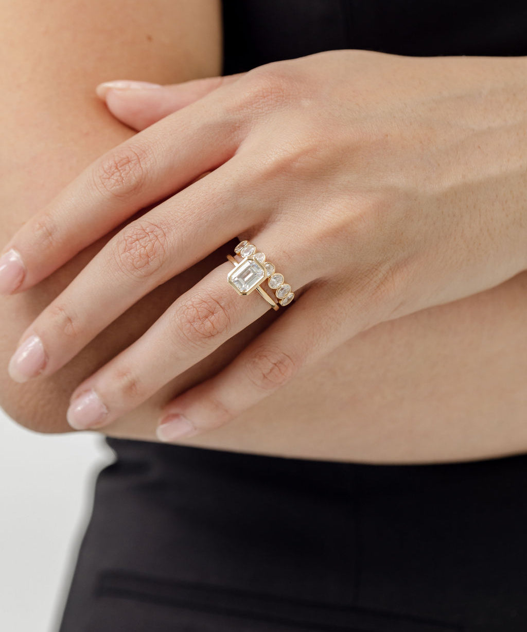 bezel set emerald cut engagement ring with bezel set oval cut diamond wedding ring