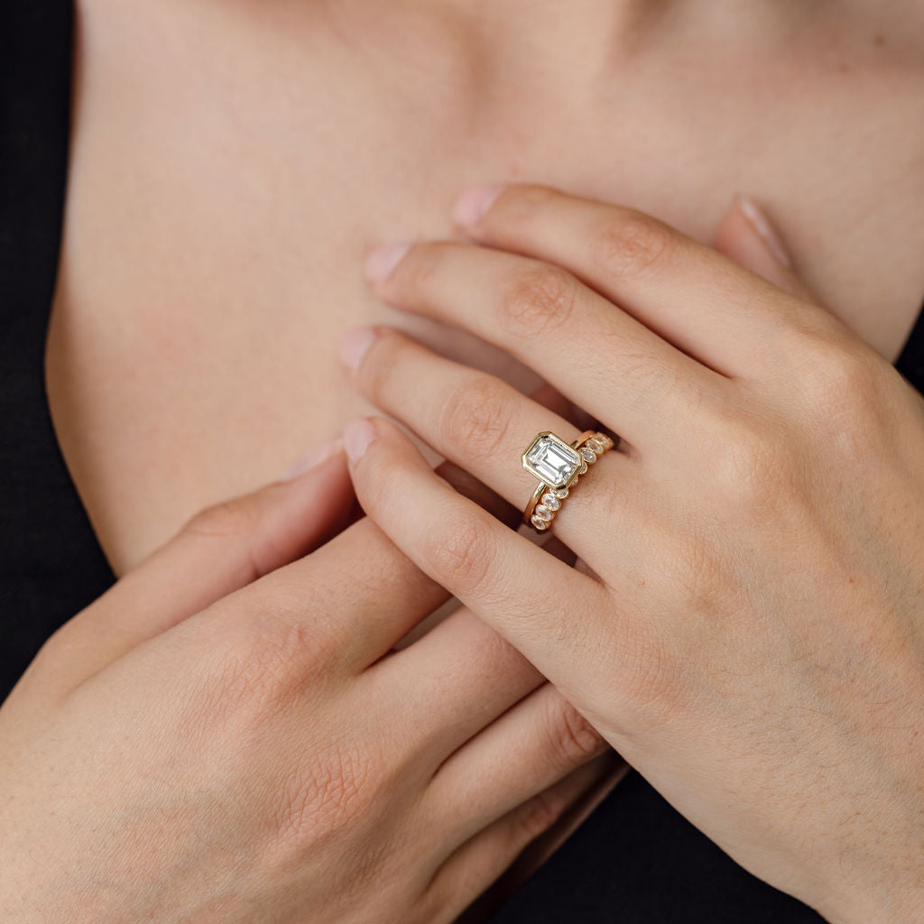 bezel set emerald cut engagement ring with bezel set oval diamond wedding ring