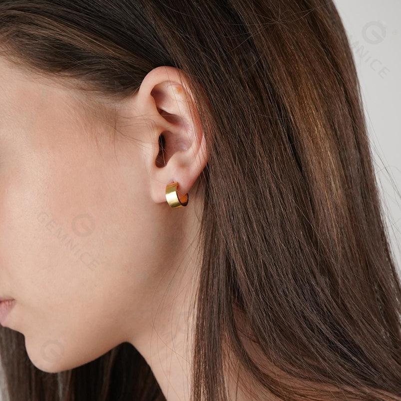 Model wearing boyfriend hoop earrings