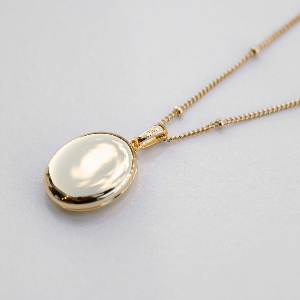 gold oval locket on bead chain necklace