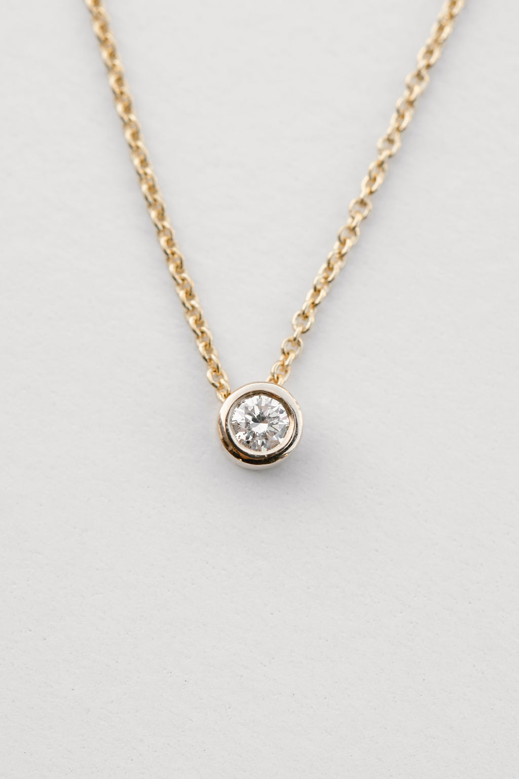 diamond bezel set necklace in yellow gold