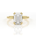 Double claw solitaire engagement ring with emerald cut diamond centre
