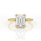 Double claw solitaire engagement ring with emerald cut diamond centre