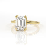Double claw solitaire engagement ring with emerald cut diamond centre