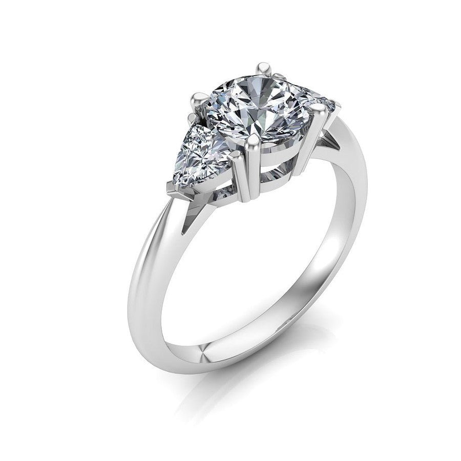white gold 3 stone trilogy moissanite engagement ring with a round centre moissanite and trilliant cut moissanite side stones