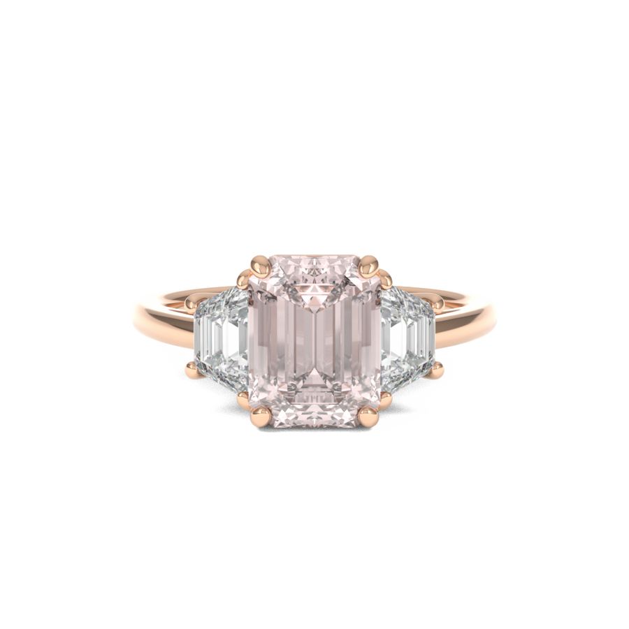 rose gold three stone trilogy engagement ring with emerald cut centre and trapezoid side stones