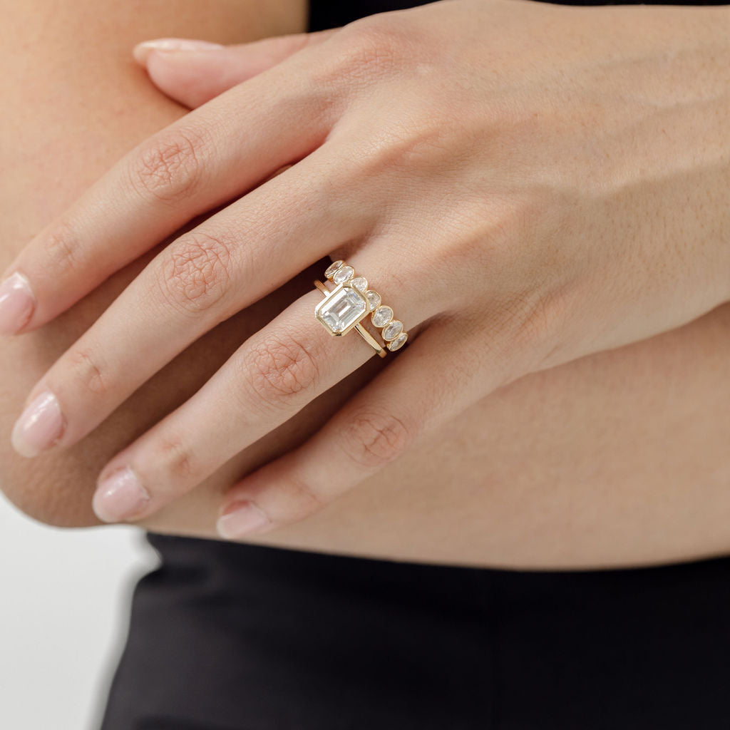 emerald cut diamond bezel set engagement ring with oval cut diamond bezel set wedding ring