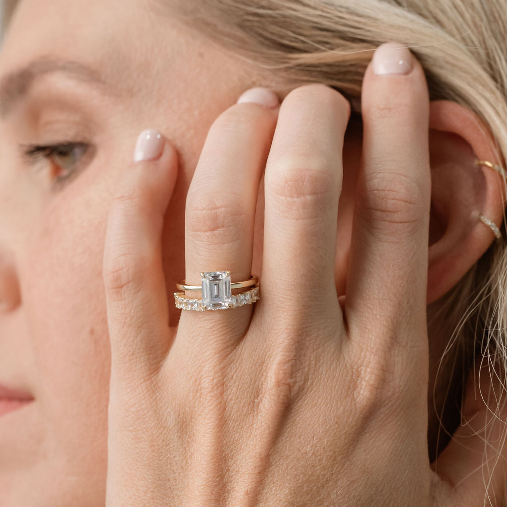 emerald cut solitaire engagement ring with statement diamond ring featuring princess cut and baguette cut diamonds
