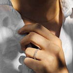 White gold diamond ring with shared claws on a  woman with a white shirt