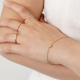 gold bracelet with diamond bezel set and fine gold stacking rings