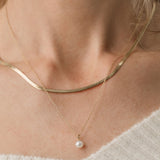 gold herringbone necklace and pearl pendant necklace