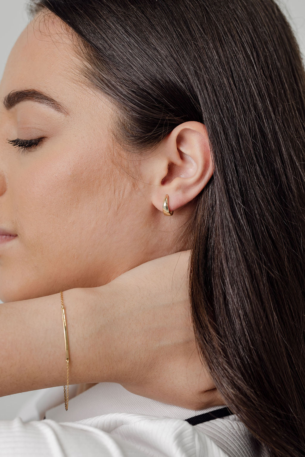 tapered gold huggie earrings and gold bar bracelet
